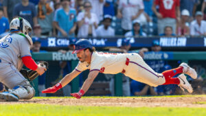 Philadelphia Phillies' Garrett Stubbs is out as he dives into home as Toronto Blue Jays catcher Alejandro Kirk (30) moves in for the tag during the 11th inning of a baseball game, Sunday, Aug. 9, 2026, in Philadelphia. (Laurence Kesterson/AP)