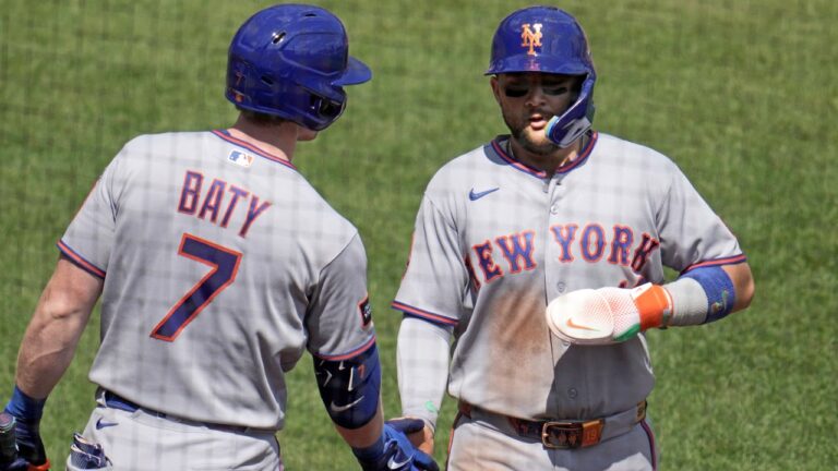 New York Mets' Bo Bichette, right, is greeted by Brett Baty as he returns to the dugout after scoring on a single hit by Jared Young off Pittsburgh Pirates pitcher Evan Sisk during the fourth inning of a baseball game in Pittsburgh, Sunday, Aug. 9, 2026. (AP Photo/Gene J. Puskar)