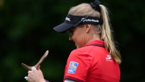 Canada's Brooke Henderson, of Smiths Falls, Ont., smiles as she checks her yardage book while walking to the fourth tee during the first round at the CPKC Canadian Women's Open LPGA golf tournament, in Edmonton, on Thursday, Aug. 20, 2026. (Darryl Dyck/CP)