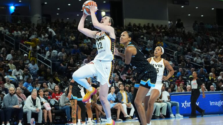 Indiana Fever guard Caitlin Clark, center left, drives to the basket past Chicago Sky forward/center Azura Stevens, center right, during the first half of a WNBA basketball game Sunday, Aug. 23, 2026, in Chicago. (AP Photo/Nam Y. Huh)