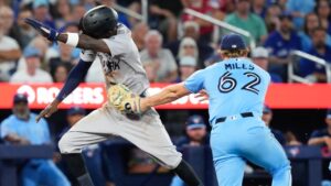Toronto Blue Jays pitcher Spencer Miles (62) catches New York Yankees' Jazz Chisholm Jr. (13) in a rundown during sixth inning MLB baseball action in Toronto on Sunday, June 14, 2026. THE CANADIAN PRESS/Chris Young