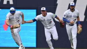 Toronto Blue Jays, from left, Brett Bateman, Myles Straw and Nathan Lukes celebrate in the outfield after their team defeated the Seattle Mariners in MLB baseball action in Toronto on Saturday, Aug. 29, 2026. (Jon Blacker/CP)