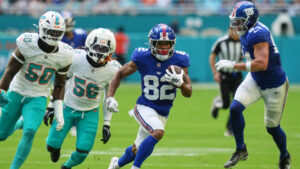 New York Giants wide receiver Calvin Austin III (82) runs the ball during the first half of a pre-season NFL football game against the Miami Dolphins, Saturday, Aug. 22, 2026, in Miami Gardens, Fla. (Lynne Sladky/AP)