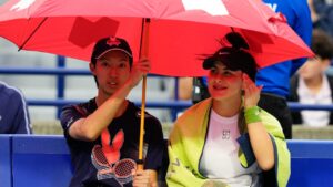 Canada's Bianca Andreescu sits under an umbrella with a ball boy as rain delays the start of her match against Czechia's Nikola Bartunkova at the National Bank Open in Toronto, Sunday, Aug. 2, 2026. (Chris Young/CP)
