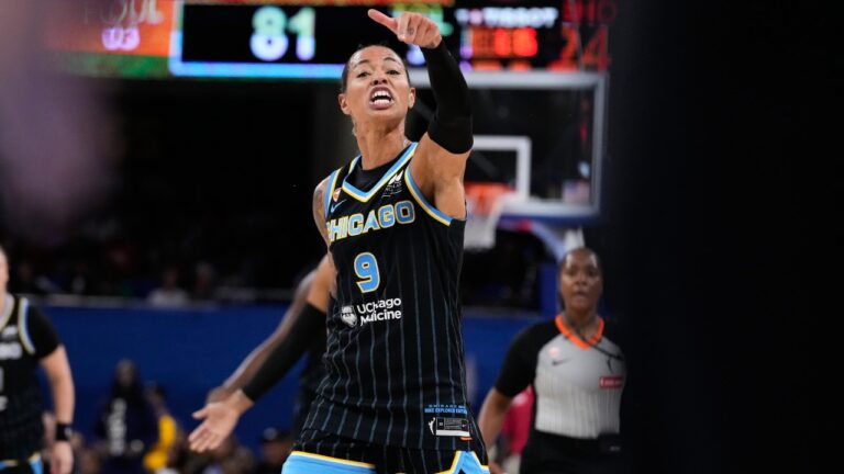 Chicago Sky guard Natasha Cloud argues with former NBA center Enes Kanter Freedom, right, during the second half of a WNBA basketball game against the Indiana Fever, Sunday, Aug. 23, 2026, in Chicago. (AP Photo/Nam Y. Huh)