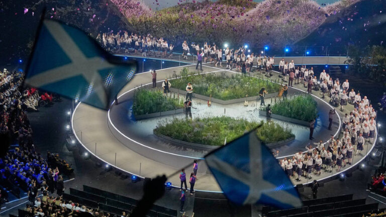 Scottish flags are waved by fans as the Scotland team arrives on stage during the Commonwealth Games opening ceremony in Glasgow, Scotland, Thursday, July 23, 2026. (Manish Swarup/AP)