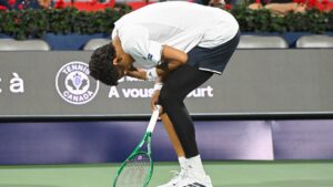 Gabriel Diallo of Canada reacts after suffering an injury during his second round match against Luciano Darderi of Italy at the National Bank Open tennis tournament in Montreal, on Tuesday, August 4, 2026. (Graham Hughes/CP)