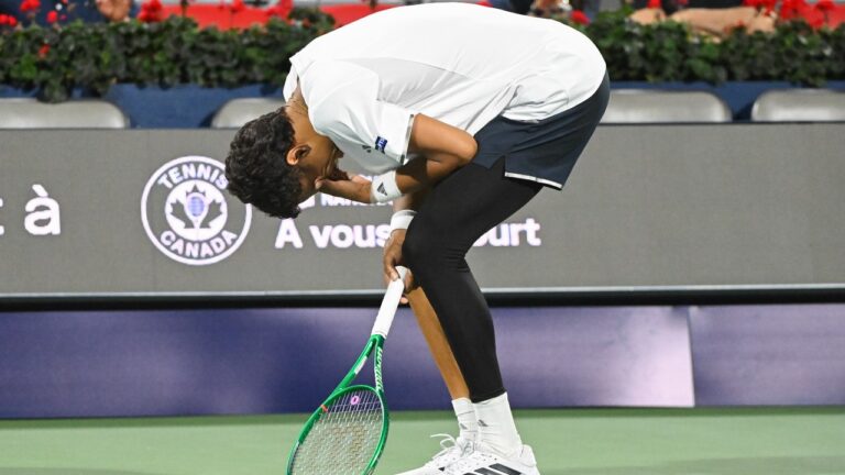 Gabriel Diallo of Canada reacts after suffering an injury during his second round match against Luciano Darderi of Italy at the National Bank Open tennis tournament in Montreal, on Tuesday, August 4, 2026. (Graham Hughes/CP)