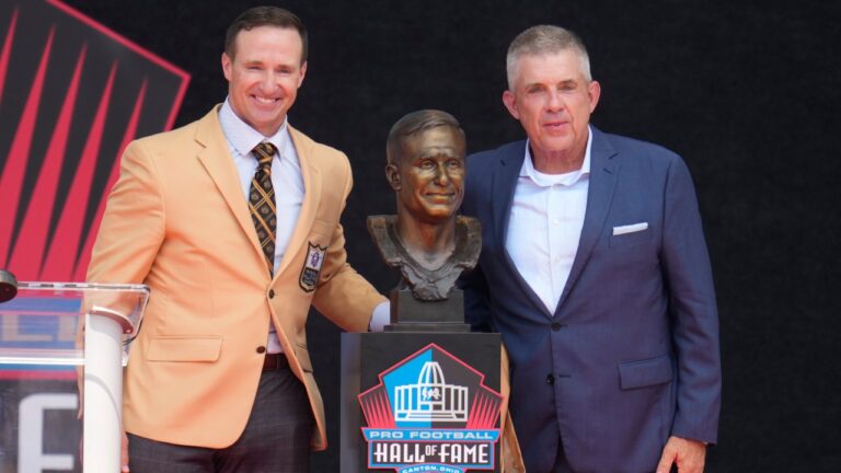 Former NFL player Drew Brees, left, unveils his bust with Sean Payton during the Pro Football Hall of Fame induction ceremony at the Pro Football Hall of Fame, in Canton, Ohio, Saturday, Aug. 8, 2026. (AP Photo/Sue Ogrocki)