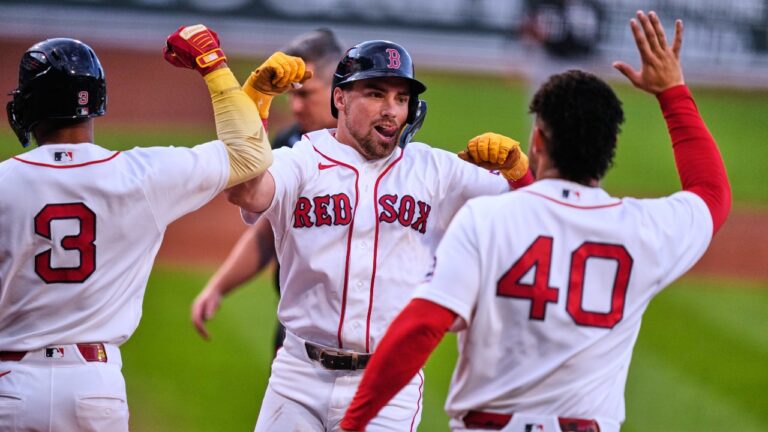 Boston Red Sox's Caleb Durbin, center, is congratulated after his grand slam off Chicago White Sox's pitcher Davis Martin during the first inning of a baseball game, Tuesday, Aug. 4, 2026, in Boston. (AP Photo/Charles Krupa)