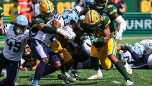 Edmonton Elks' Noah Taylor (42) tackles Toronto Argonauts' Isaiah Smith (21) during second half CFL football action in Edmonton on Saturday, Aug. 15, 2026. (Codie McLachlan/CP)