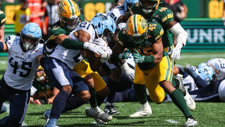 Edmonton Elks' Noah Taylor (42) tackles Toronto Argonauts' Isaiah Smith (21) during second half CFL football action in Edmonton on Saturday, Aug. 15, 2026. (Codie McLachlan/CP)