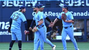 Toronto Blue Jays, from left, Ernie Clement, Nathan Lukes, Andres Gimenez, centre, and Myles Straw celebrate their team's victory over the New York Yankess in MLB baseball action in Toronto, Saturday, Aug. 15, 2026. (Jon Blacker/CP)