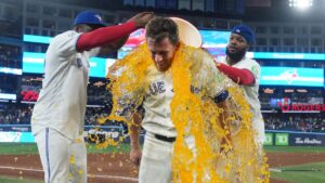 Toronto Blue Jays outfielder Myles Straw (3) gets Gatorade dumped on him by teammates Vladimir Guerrero Jr. (27) and Jesús Sánchez (12) after defeating the Boston Red Sox during ninth inning American League MLB baseball action in Toronto on Wednesday, August 12, 2026. (Nathan Denette/CP)