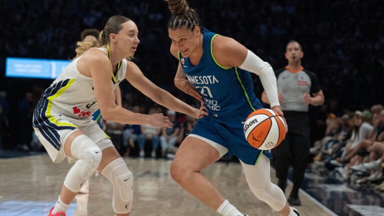 Minnesota Lynx guard Kayla McBride (21) drives to the basket on Dallas Wings guard Paige Bueckers in the first half of a basketball game, Sunday Aug. 9, 2026 in Minneapolis. (Jerry Holt/Minnesota Star Tribune via AP)