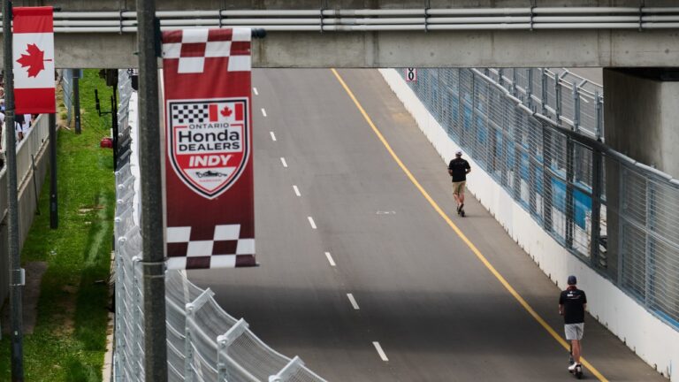 Race personnel scooter along empty racetracks as preparations continue ahead of the 2026 Honda Indy in Markham, Ont., Friday, Aug. 14, 2026. (Sammy Kogan/CP)