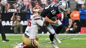 San Francisco 49ers defensive end Keion White (56) sacks Las Vegas Raiders quarterback Fernando Mendoza (15) during the first half of an NFL preseason football game, Thursday, Aug. 27, 2026}, in Las Vegas. (AP Photo/David Becker)