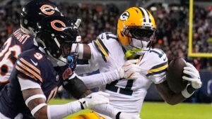 Green Bay Packers' Jayden Reed catches a pass with Chicago Bears' Nahshon Wright and Jaquan Brisker defending during the first half of an NFL wild-card playoff football game Jan. 10, 2026, in Chicago. (Erin Hooley/AP)