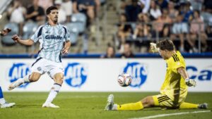 CF Montreal goalkeeper Sebastian Breza (1) makes a save on New England Revolution's Dor Turgeman (99) durins second half MLS soccer action in Montreal on Saturday, August 1, 2026. (Christopher Katsarov/CP)