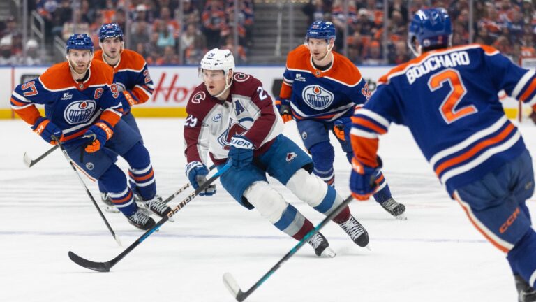 Colorado Avalanche's Nathan MacKinnon (29) is surrounded by Edmonton Oilers' Connor McDavid (97), Matt Savoie (22), Vasily Podkolzin (92) and Evan Bouchard (2) during first period NHL action, in Edmonton on Monday, April 13, 2026. (Jason Franson/CP)