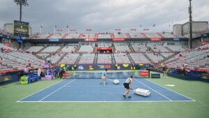 Ground crew dry centre court during a rain delay at the National Bank Open tennis tournament in Montreal, on Sunday, August 2, 2026. (Graham Hughes/CP)