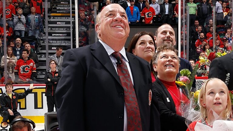 Former Calgary Flames broadcaster Peter Maher and his family watch a video honouring his career during a pre game ceremony against the Anaheim Ducks at Scotiabank Saddledome on November 18, 2014 in Calgary, Alberta, Canada. (Photo by Gerry Thomas/NHLI via Getty Images)