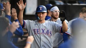 Texas Rangers' Corey Seager celebrates with teammates in the dugout after scoring on a Ezequiel Duran single during the second inning of a baseball game against the Chicago White Sox in Chicago, Monday, Aug. 24, 2026. (AP Photo/Paul Beaty)