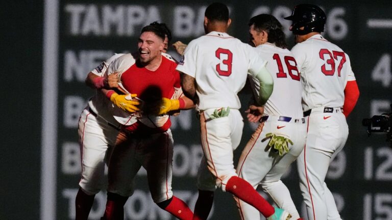 Boston Red Sox's Caleb Durbin, left, celebrates with teammates after his game-winning RBI single during the 13th inning of a baseball game against the Chicago White Sox, Thursday, Aug. 6, 2026, in Boston. (AP Photo/Charles Krupa)