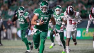 Saskatchewan Roughriders quarterback Tommy Stevens (17) runs the ball for a touchdown against the Ottawa Redblacks during second half CFL football action in Regina on Friday, August 7, 2026. (Kayle Neis/CP)