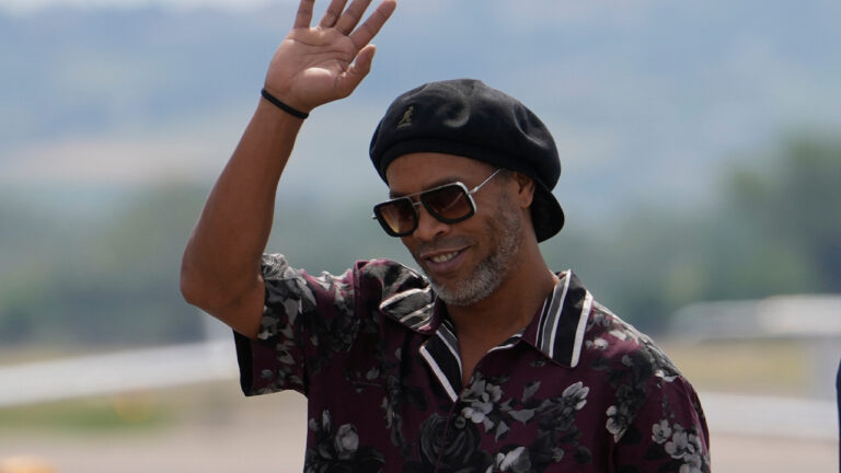 Former soccer star Ronaldinho acknowledges the media as he arrives at the airport ahead the Ravenna Serie C, 2026 soccer team presentation, joining the club as a technical coach and playing in one match in Ravenna, Italy, Thursday, Aug. 20, 2026. (Luca Bruno/AP)