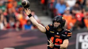 BC Lions quarterback Nathan Rourke (12) throws the ball to Jevon Cottoy, not seen, for a touch down during the first half of a CFL football game in Vancouver on Sunday, Aug. 23, 2026. (Ethan Cairns/CP)