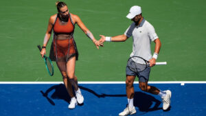 Aryna Sabalenka, of Belarus, and Novak Djokovic, of Serbia, high-five during a mixed doubles match at the US Open tennis championships, Tuesday, Aug. 25, 2026, in New York. (Yuki Iwamura/AP)