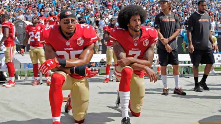 San Francisco 49ers' Colin Kaepernick (7) and Eric Reid (35) kneel during the national anthem before an NFL football game against the Carolina Panthers in Charlotte, N.C., Sunday, Sept. 18, 2016. (Mike McCarn/AP)