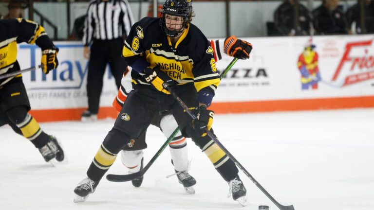 Bowling Green forward Owen Ozar (22) and Michigan Tech forward Stiven Sardarian (6) battle for the puck during an NCAA hockey game on Friday, Nov. 29, 2024, in Bowling Green, Ohio. (Rick Osentoski/AP)