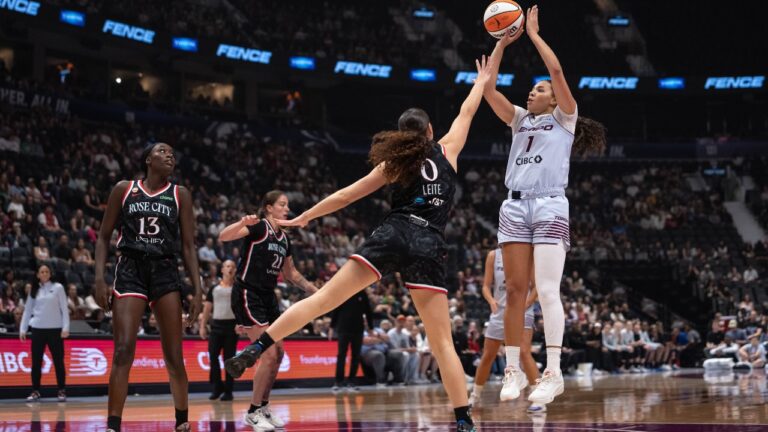 Toronto Tempo's Kiki Rice (1) shoots the ball as Portland Fire's Carla Leite (0) defends and Nyadiew Puoch (13) watches during the first half of a WNBA basketball game in Vancouver, on Friday, August 21, 2026. (Ethan Cairns/CP)
