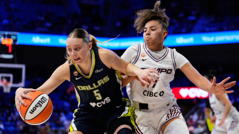 Dallas Wings guard Paige Bueckers (5) works for a shot as Toronto Tempo guard Kiki Rice (1) defends in the first half of a WNBA basketball game in Arlington, Texas, Wednesday, Aug. 12, 2026. (Tony Gutierrez/AP)