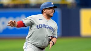 Toronto Blue Jays' Alejandro Kirk races home to score on an RBI single by George Springer off Tampa Bay Rays pitcher Nick Martinez during the first inning of a baseball game Tuesday, Aug. 18, 2026, in St. Petersburg, Fla. (Chris O'Meara/AP)