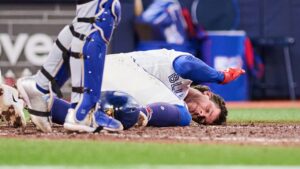 Toronto Blue Jays' Ernie Clement (22) reacts after being hit by a foul ball during eighth inning MLB baseball action against the Kansas City Royals in Toronto, on Tuesday, Aug. 25, 2026. (Sammy Kogan/CP)