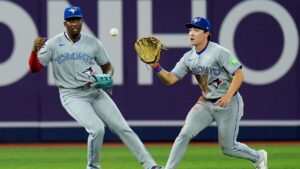 Toronto Blue Jays center fielder Brett Bateman, right, fields a single in front of right fielder Jesus Sanchez by Tampa Bay Rays' Cedric Mullins during the fourth inning of a baseball game Tuesday, Aug. 18, 2026, in St. Petersburg, Fla. (Chris O'Meara/AP)