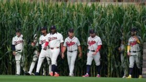 Players walk onto the field before a baseball game between the Minnesota Twins and the Philadelphia Phillies at the Field of Dreams movie site, Thursday, Aug. 13, 2026, in Dyersville, Iowa. (AP Photo/Charlie Neibergall)