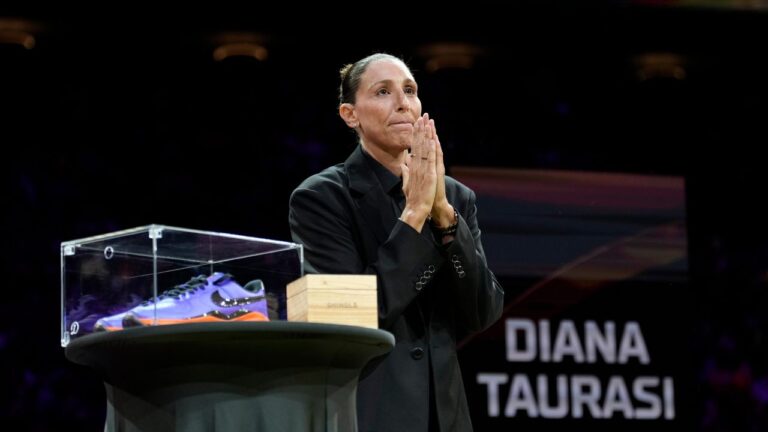 Retired WNBA Phoenix Mercury basketball player Diana Taurasi acknowledges the cheering crowd as she is honored during a halftime Ring of Honor ceremony Sunday, Aug. 16, 2026, in Phoenix. (AP Photo/Ross D. Franklin)
