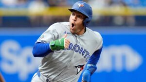 Toronto Blue Jays' George Springer reacts as he scores on an RBI double by Jesús Sánchez off Tampa Bay Rays pitcher Nick Martinez during the first inning of a baseball game Tuesday, Aug. 18, 2026, in St. Petersburg, Fla. (AP Photo/Chris O'Meara)