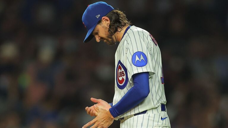 Chicago Cubs' Kevin Gausman grabs his hand after a pitch a strike out during the fourth inning of a baseball game against the Chicago White Sox, Tuesday, Aug. 18, 2026, in Chicago. (AP Photo/Melissa Tamez)