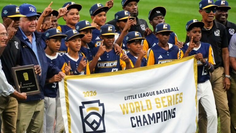 Curacao poses with the champions banner after winning the Little League World Series Championship baseball game against Henderson, Nev., in South Williamsport, Pa., Sunday, Aug. 30, 2026. (AP Photo/Gene J. Puskar)
