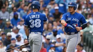 Toronto Blue Jays' Kazuma Okamoto, of Japan, right, celebrates with teammate Nathan Lukes (38) after scoring on a disengagement violation during the first inning of a baseball game against the Chicago Cubs in Chicago, Thursday, Aug. 6, 2026. (AP Photo/Paul Beaty)