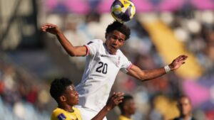 United States' Zavier Gozo heads the ball challenged by South Africa's Gomolemo Kekana during a FIFA U-20 World Cup Group E soccer match at El Teniente Stadium in Rancagua, Chile, Sunday, Oct. 5, 2025. (Andre Penner/AP)