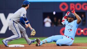 Toronto Blue Jays' Jesus Sanchez slides into second base with a double as Kansas City Royals shortstop Bobby Witt Jr. defends during second-inning MLB action in Toronto, on Wednesday, Aug. 26, 2026. (Sammy Kogan/CP)