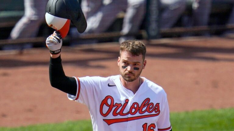 Trey Mancini tips his helmet as fans give him a standing ovation prior to a baseball game on April 8, 2021, Opening Day in Baltimore. (Julio Cortez/AP)