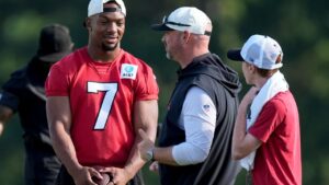 Atlanta Falcons running back Bijan Robinson speaks to a coach during training camp, Monday, Aug. 3, 2026, in Flowery Branch, Ga. (Mike Stewart/AP)