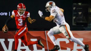 B.C. Lions' Mathieu Betts, right, chases down Calgary Stampeders quarterback Vernon Adams Jr. during second half CFL football action in Calgary, Thursday, Aug. 13, 2026. (Jeff McIntosh/CP)